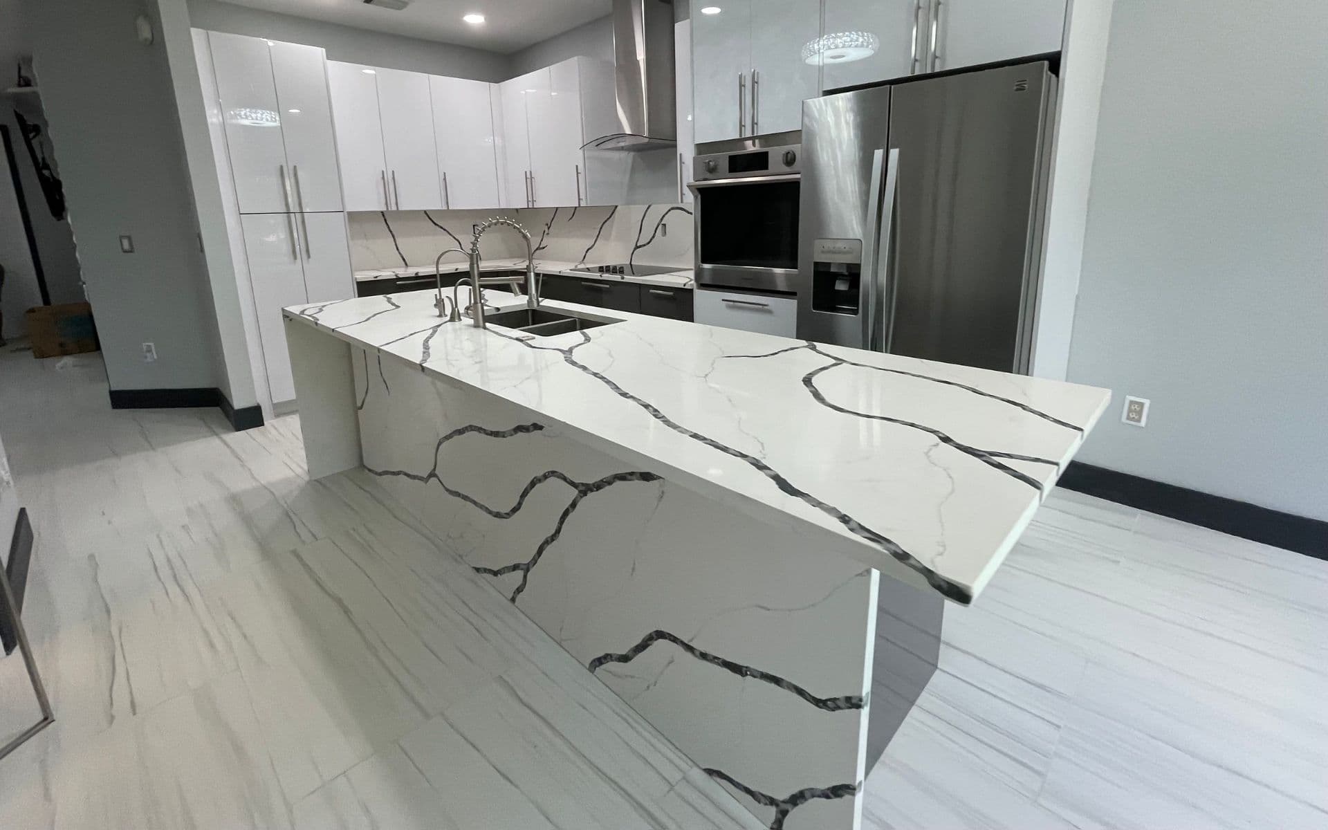 Kitchen remodel with waterfall island — Boca Raton residence, Palm Beach County